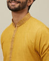 alt message - Manyavar Men Candlelight Orange Bel Buti Patterned Placket Kurta Set image number 1