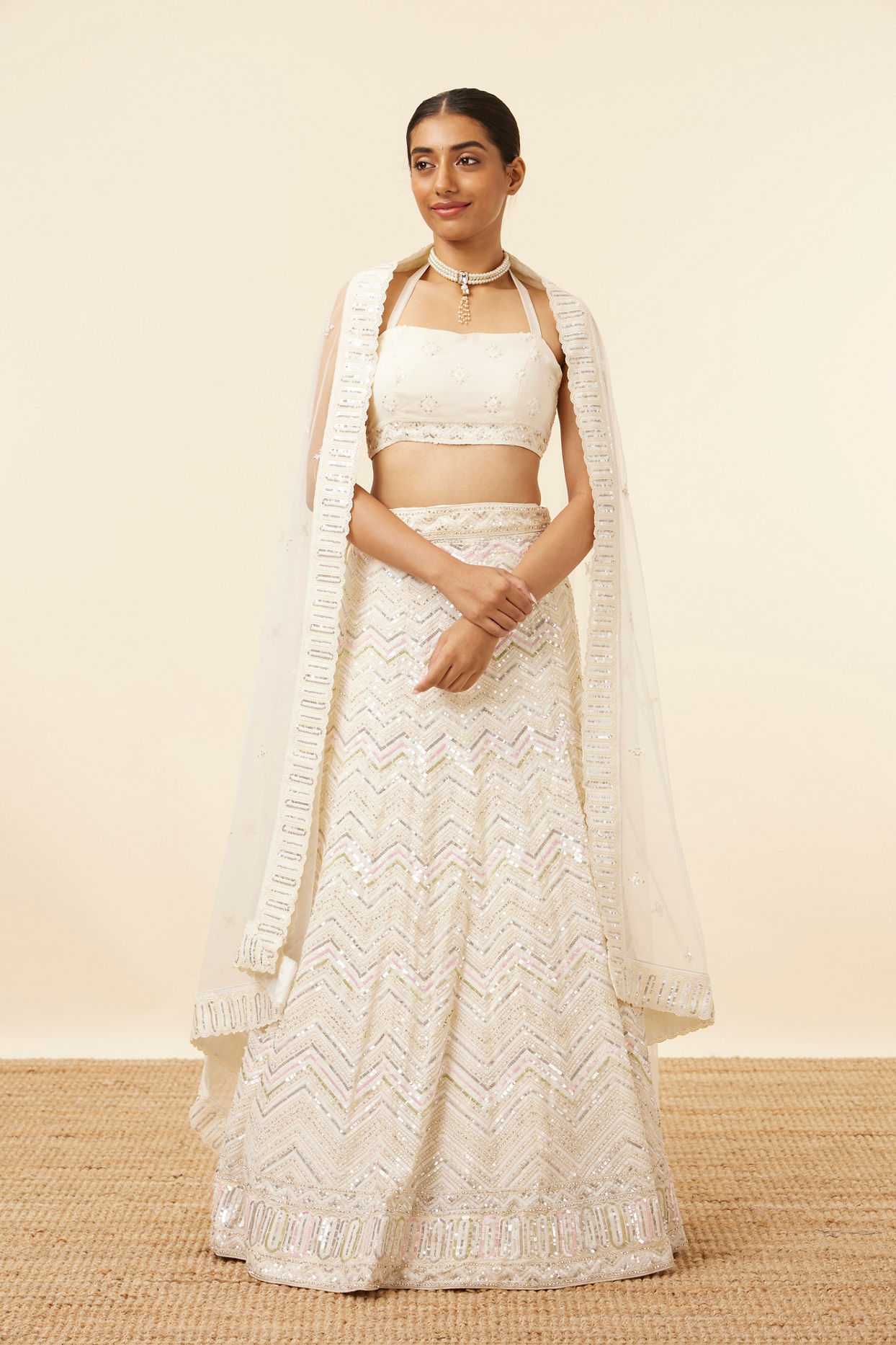 alt message - Mohey Women Light Cream Patterned Lehenga image number 0