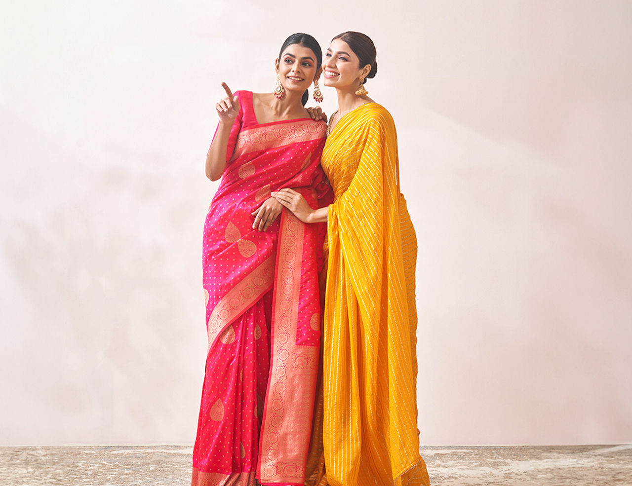 Women wearing Yellow and Pink Saree