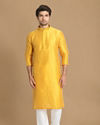 alt message - Manyavar Men Golden Yellow Solid Kurta Set image number 1