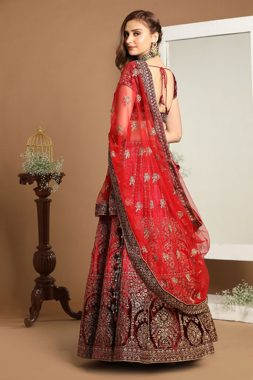 Mohey Women Rani And Maroon Velvet Zari Embroidered Bridal Lehenga