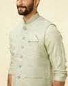 alt message - Manyavar Men Tea Green Bel Buti Patterned Drape Detailed Kurta Jacket Set image number 1