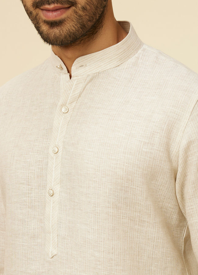 alt message - Manyavar Men Warm White Self Patterned Kurta image number 1