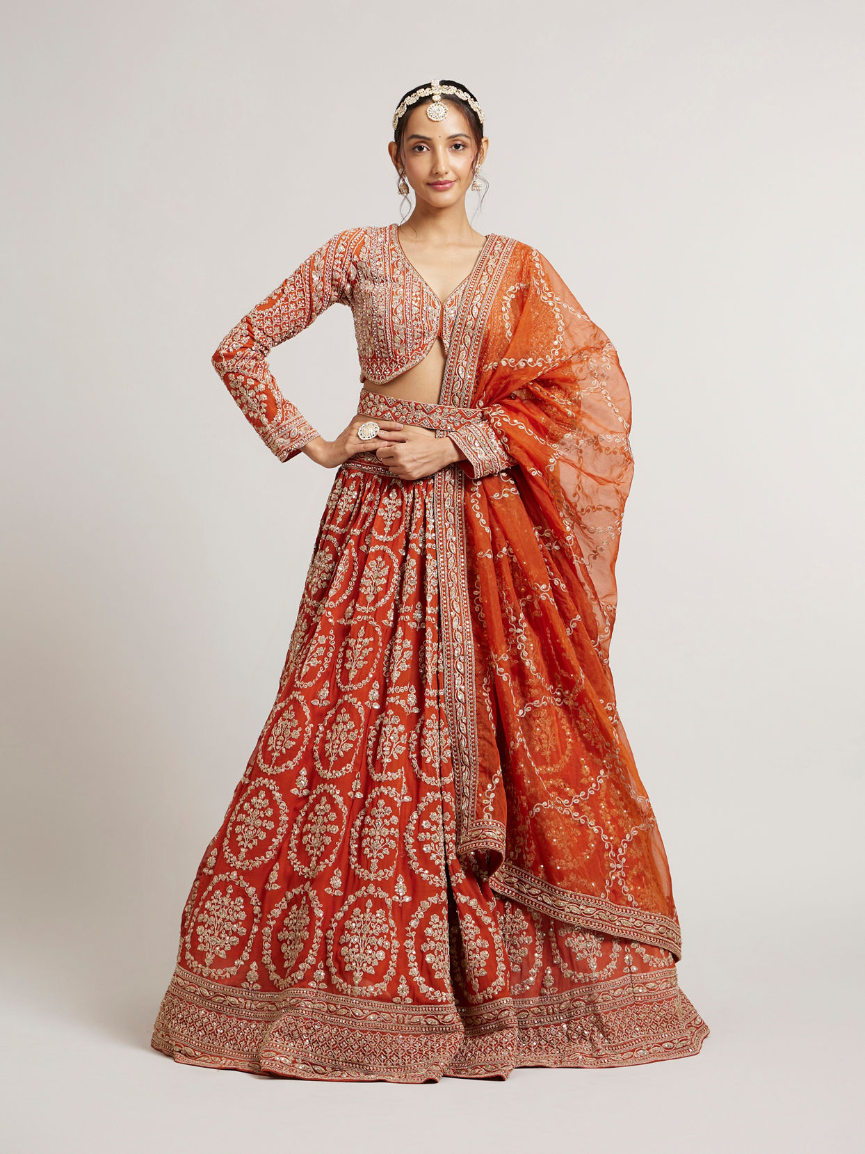 Mohey Women Rust Orange Floral Medallion Patterned Lehenga with Bel Buti Embroidery on Blouse