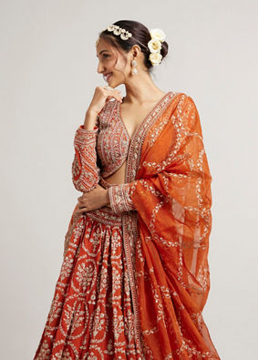 Mohey Women Rust Orange Floral Medallion Patterned Lehenga with Bel Buti Embroidery on Blouse