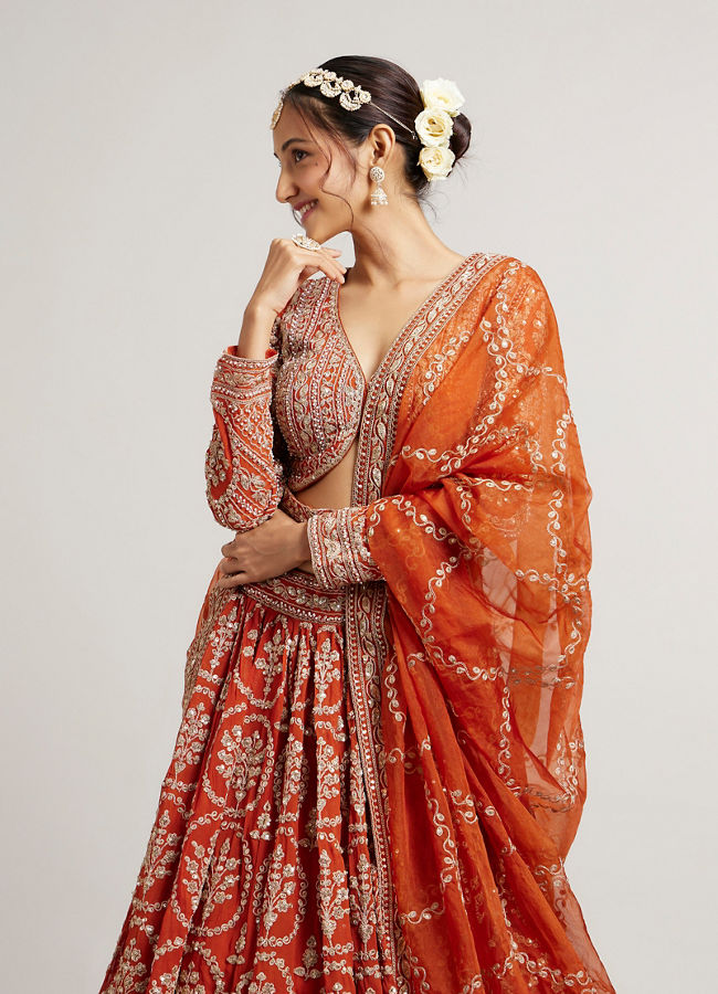 Mohey Women Rust Orange Floral Medallion Patterned Lehenga with Bel Buti Embroidery on Blouse