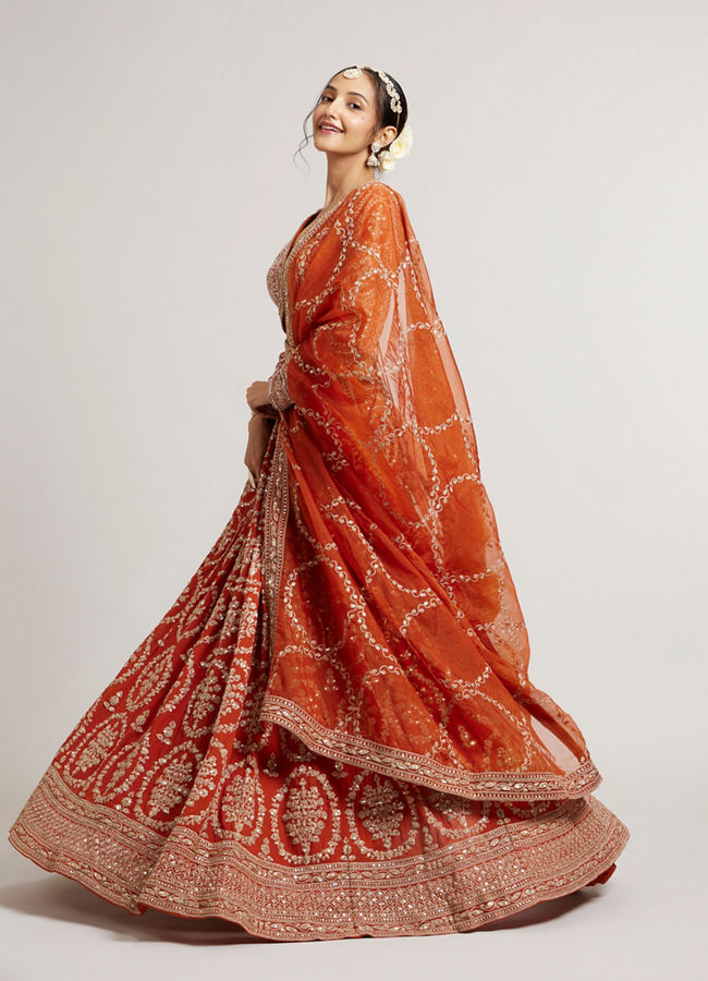 Mohey Women Rust Orange Floral Medallion Patterned Lehenga with Bel Buti Embroidery on Blouse