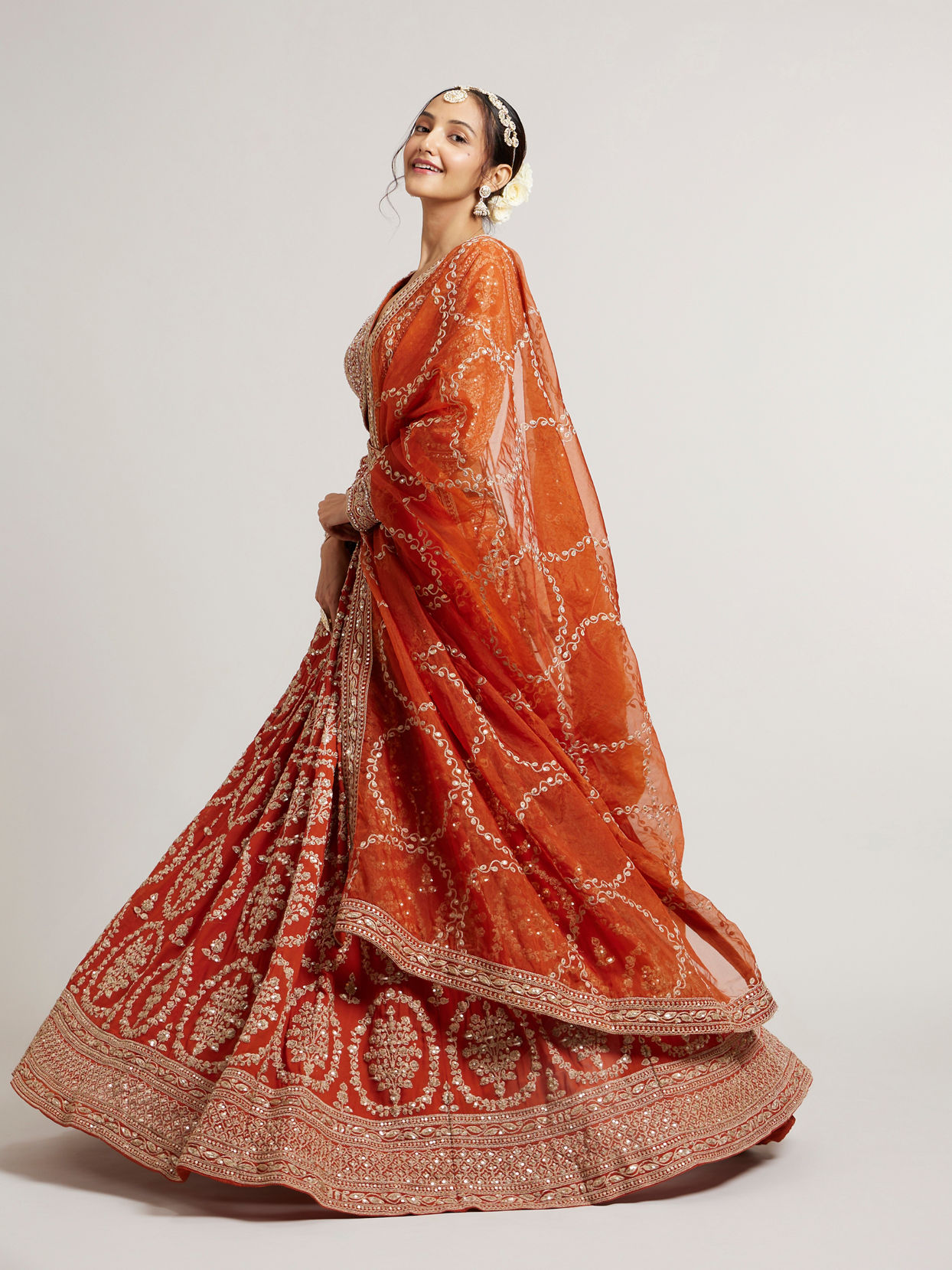 Mohey Women Rust Orange Floral Medallion Patterned Lehenga with Bel Buti Embroidery on Blouse