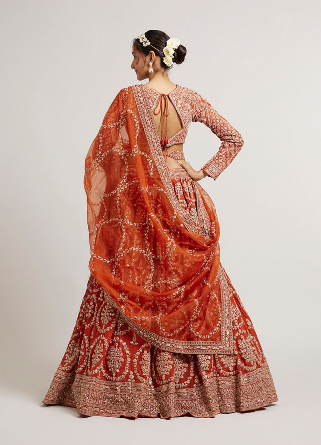 Mohey Women Rust Orange Floral Medallion Patterned Lehenga with Bel Buti Embroidery on Blouse