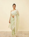 alt message - Mohey Women Pistachio Green Saree with Floral Vine Patterned Borders image number 0