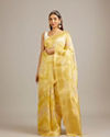 Canary Yellow Floral Grid Patterned Saree with Intricate Borders And Tassel Trims