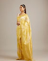 Mohey Women Canary Yellow Floral Grid Patterned Saree with Intricate Borders And Tassel Trims