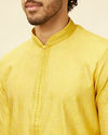 alt message - Manyavar Men Illuminating Yellow Bel Buti Patterned Kurta Set image number 1