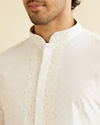 alt message - Manyavar Men Warm White Self Textured Kurta Set with Embroidered Neckline image number 1