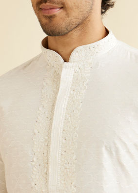 alt message - Manyavar Men Warm White Self Textured Kurta Set with Embroidered Neckline image number 1