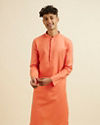 alt message - Manyavar Men Orange Plain Kurta Set image number 0