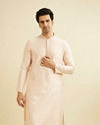 Pale Peach Grid Patterned Kurta Set with Embellished Neckline