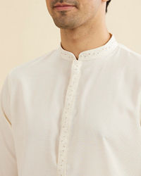 Manyavar Men Warm White Self Textured Kurta Set with Embellished Neckline