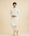 Manyavar Men Warm White Self Textured Kurta Set with Embellished Neckline