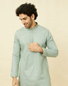 alt message - Manyavar Men Turkish Green Diamond Patterned Kurta Set image number 0