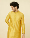 alt message - Manyavar Men Amber Yellow Kurta Set with Floral Embroidered Neckline image number 0