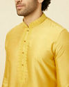 alt message - Manyavar Men Amber Yellow Kurta Set with Floral Embroidered Neckline image number 1