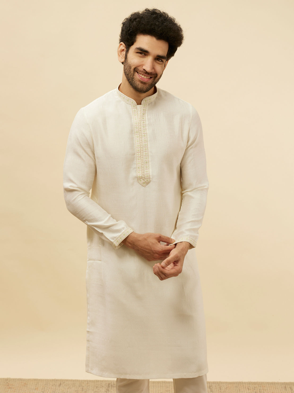 alt message - Manyavar Men Warm White Embroidered Neckline Kurta Set image number 0