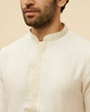 alt message - Manyavar Men Warm White Embroidered Neckline Kurta Set image number 1