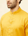 alt message - Manyavar Men Sunrise Orange Self Patterned Kurta Set image number 1