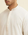 alt message - Manyavar Men Warm White Self Patterned Mirror Work Kurta Set image number 1