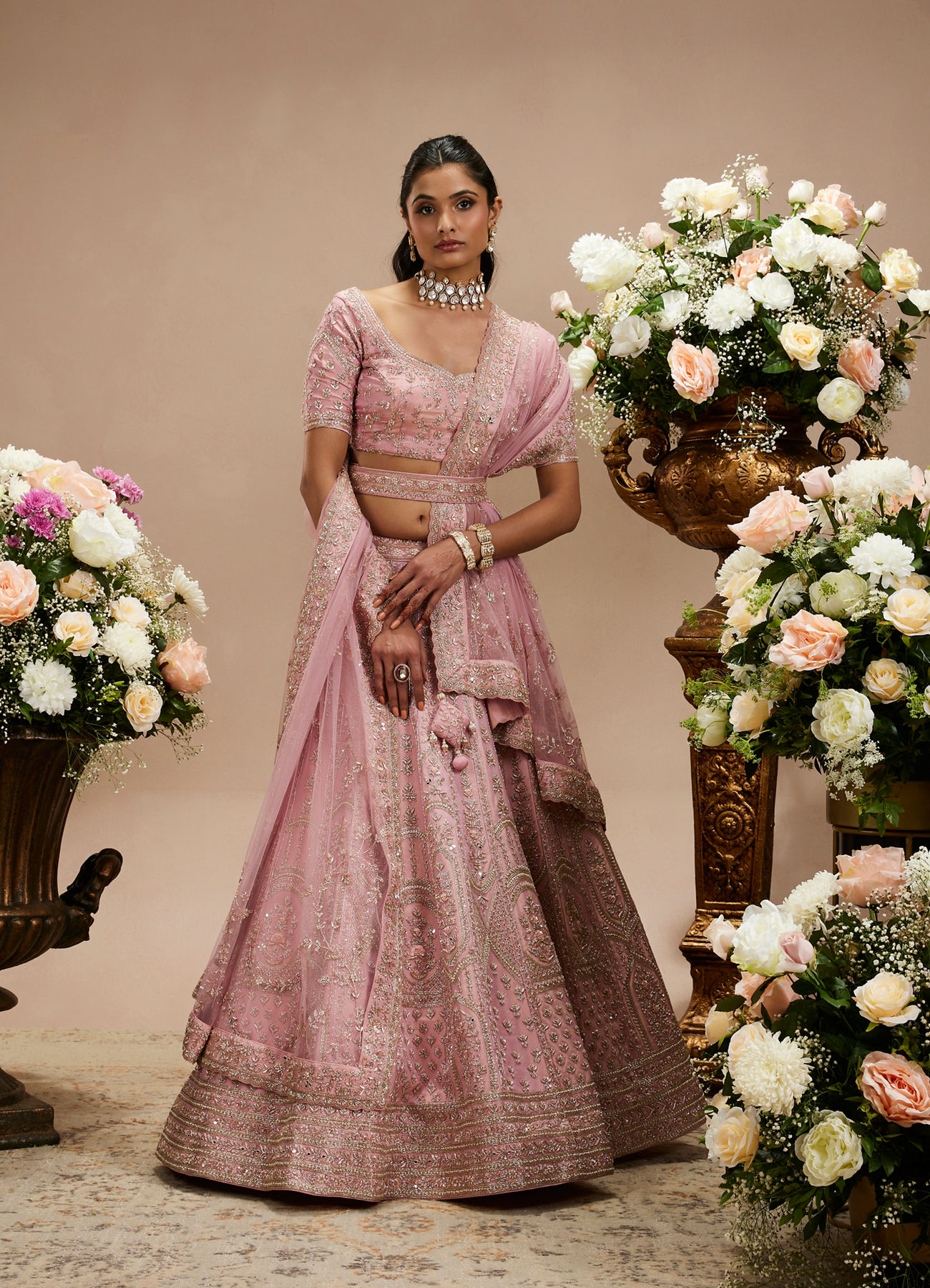 Twamev Women Baby Pink Zari Embroidered Lehenga with Floral And Buta Motifs And Pillow Trim Latkans
