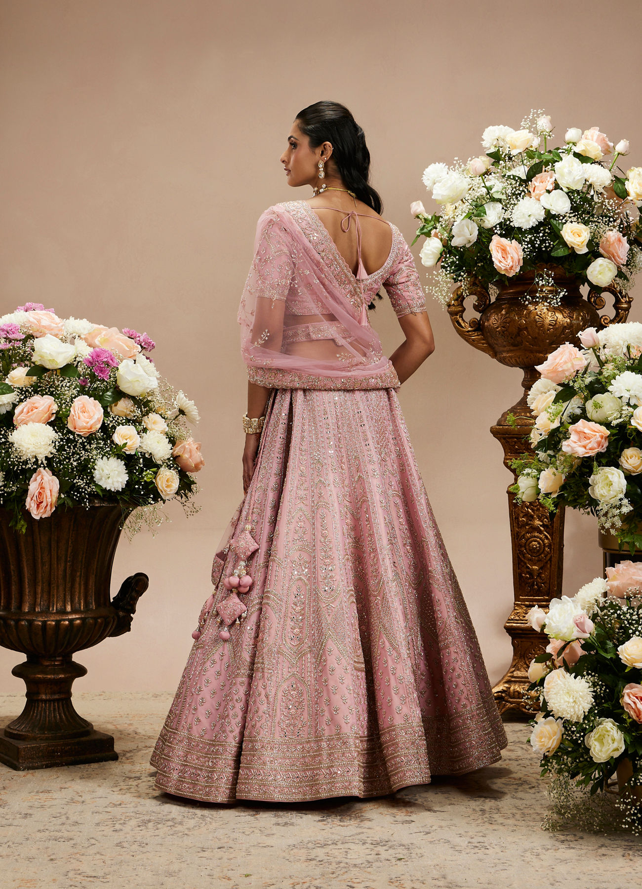 Twamev Women Baby Pink Zari Embroidered Lehenga with Floral And Buta Motifs And Pillow Trim Latkans