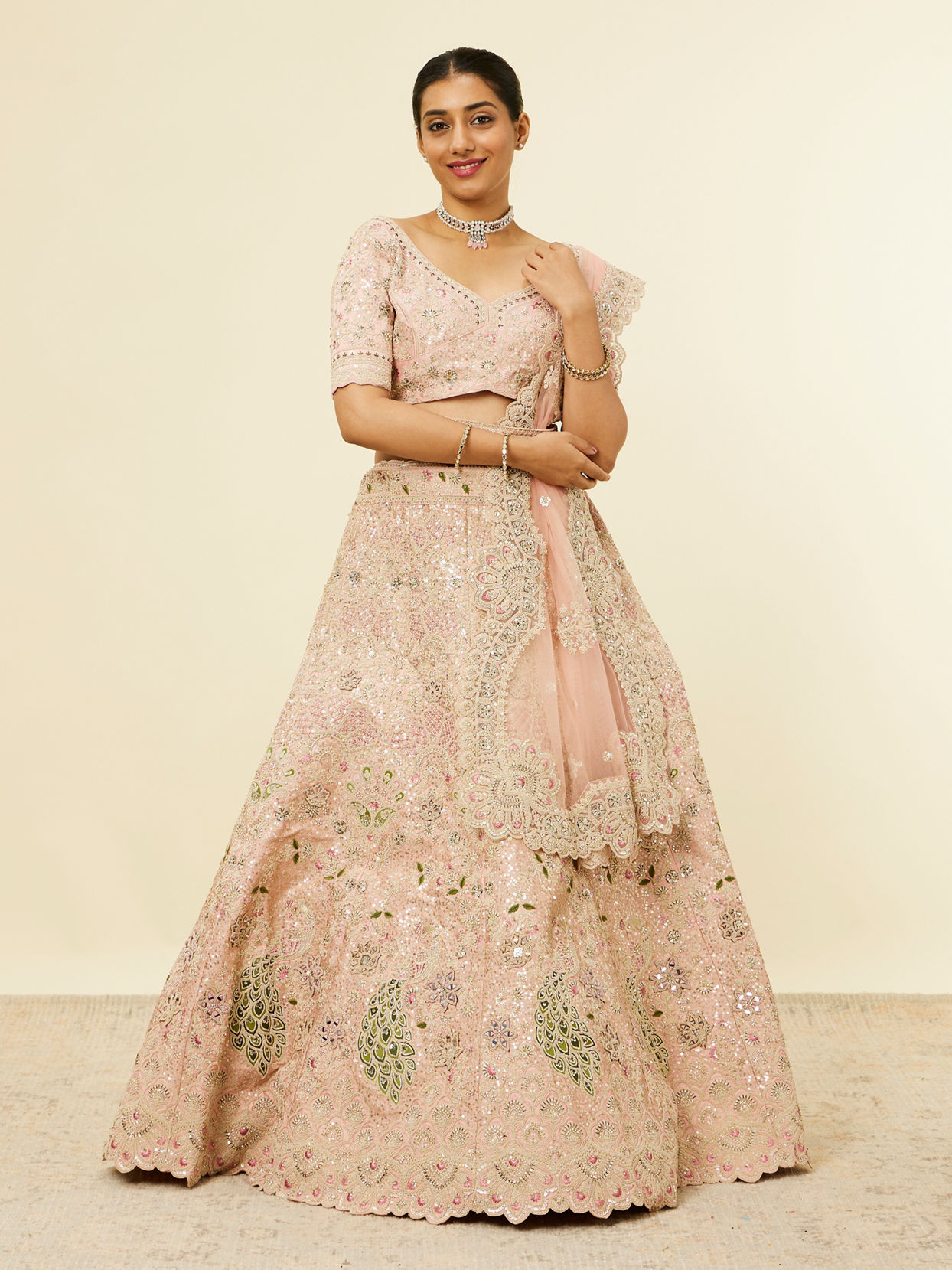 alt message - Mohey Women Golden Pink Sitara Embroidered Lehenga with Peacock Motifs image number 0