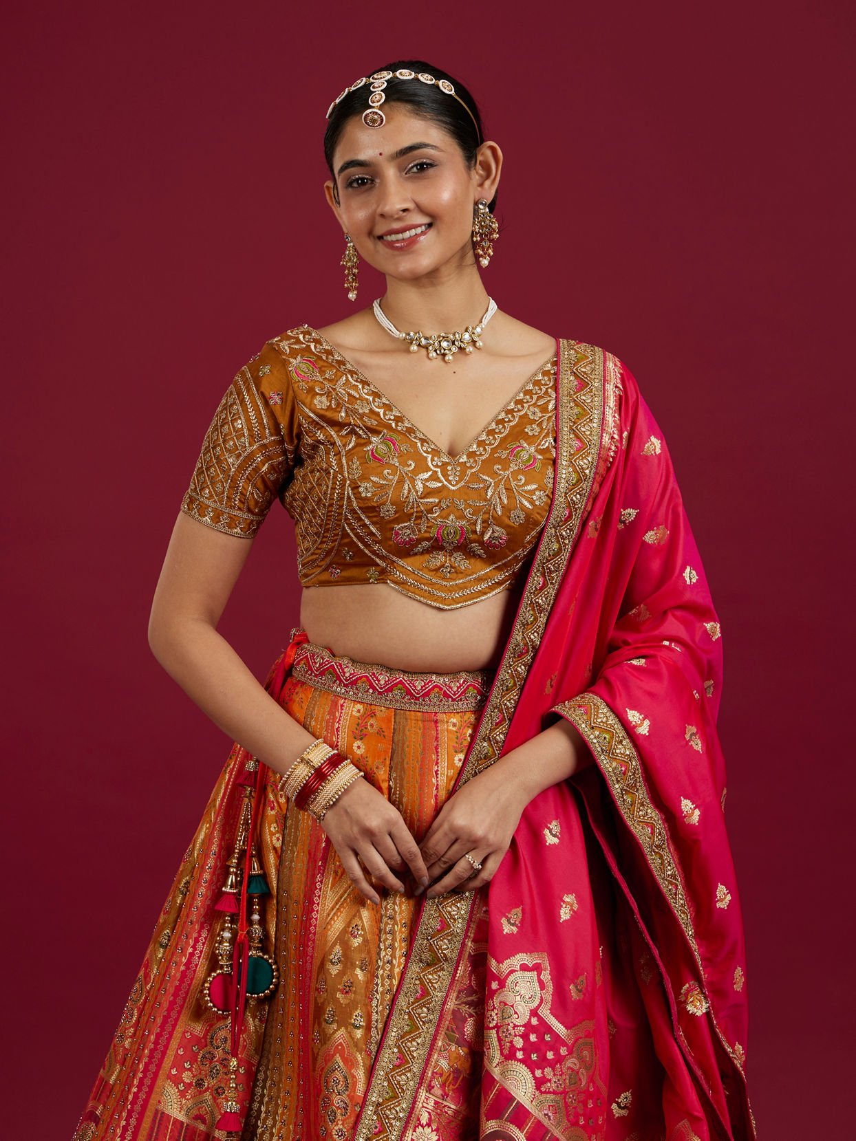 Mohey Women Orange and Pink Aari Embroidered Benarasi Lehenga