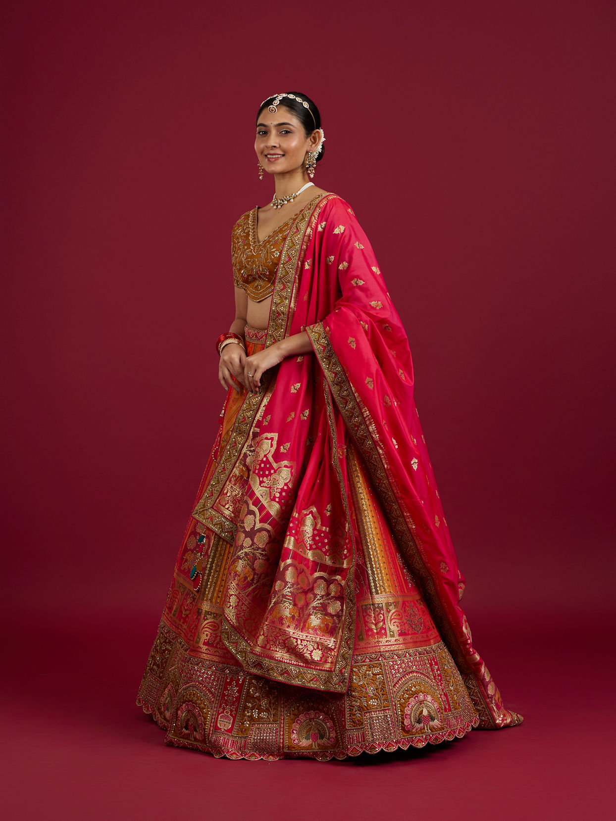 Mohey Women Orange and Pink Aari Embroidered Benarasi Lehenga