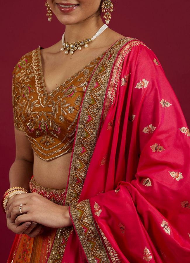 Mohey Women Orange and Pink Aari Embroidered Benarasi Lehenga