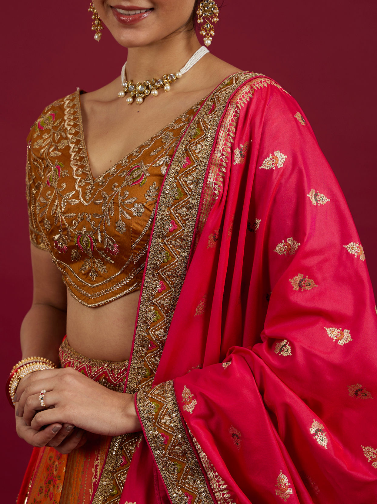 Mohey Women Orange and Pink Aari Embroidered Benarasi Lehenga