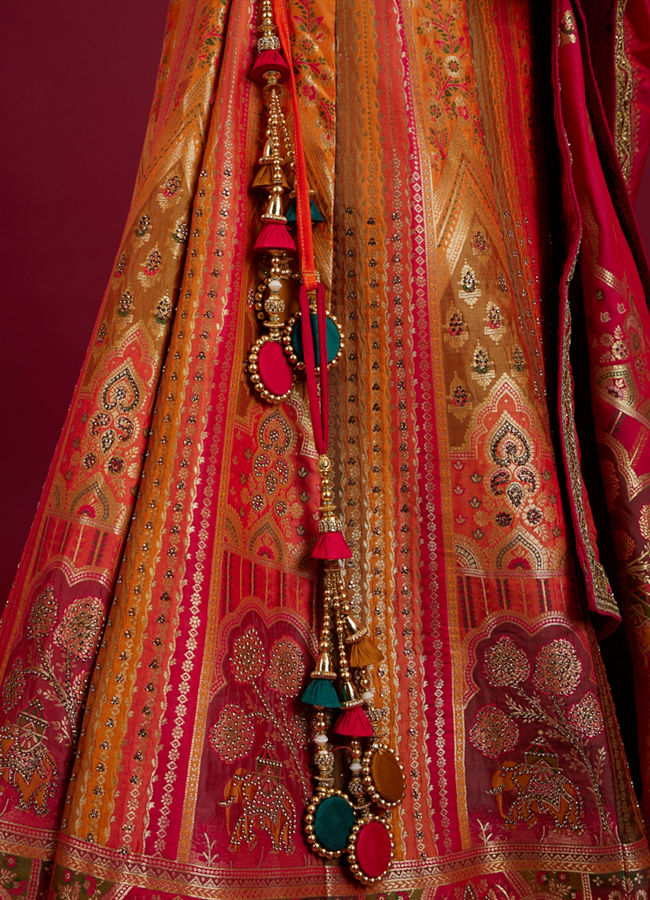 Mohey Women Orange and Pink Aari Embroidered Benarasi Lehenga