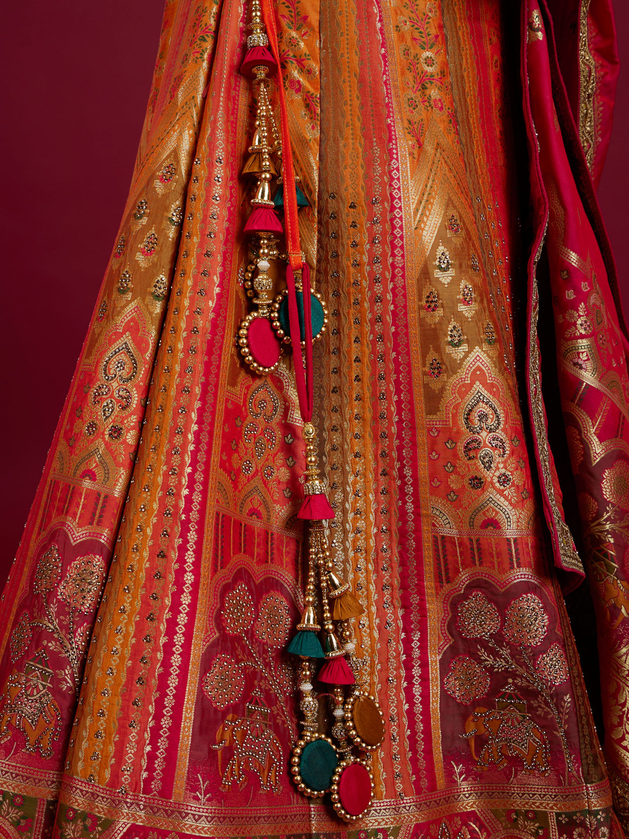Mohey Women Orange and Pink Aari Embroidered Benarasi Lehenga