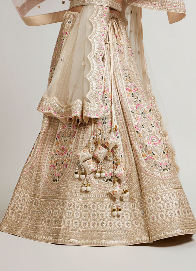 Mohey Women Soft Cream Floral Embroidered Lehenga with Sequin Work And Pillow Trim Latkans