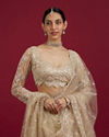 Mohey Women Soft Beige Scallop Patterned Lehenga with Sequin Embroidery And Potli Trim Latkans