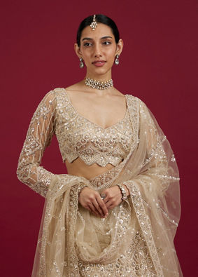 Mohey Women Soft Beige Scallop Patterned Lehenga with Sequin Embroidery And Potli Trim Latkans
