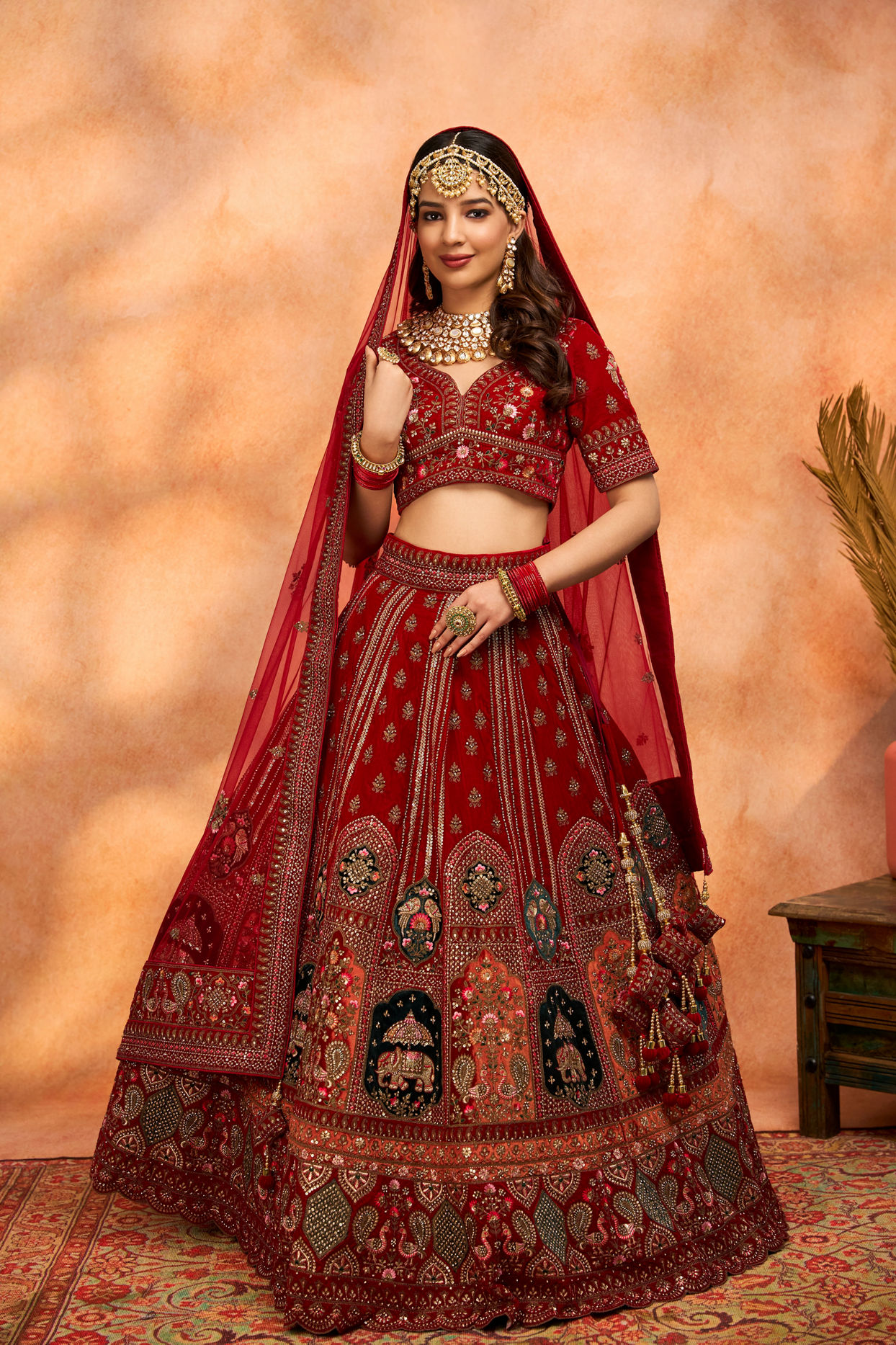 alt message - Mohey Women Dark Red Velvet Crop Top Lehenga image number 0