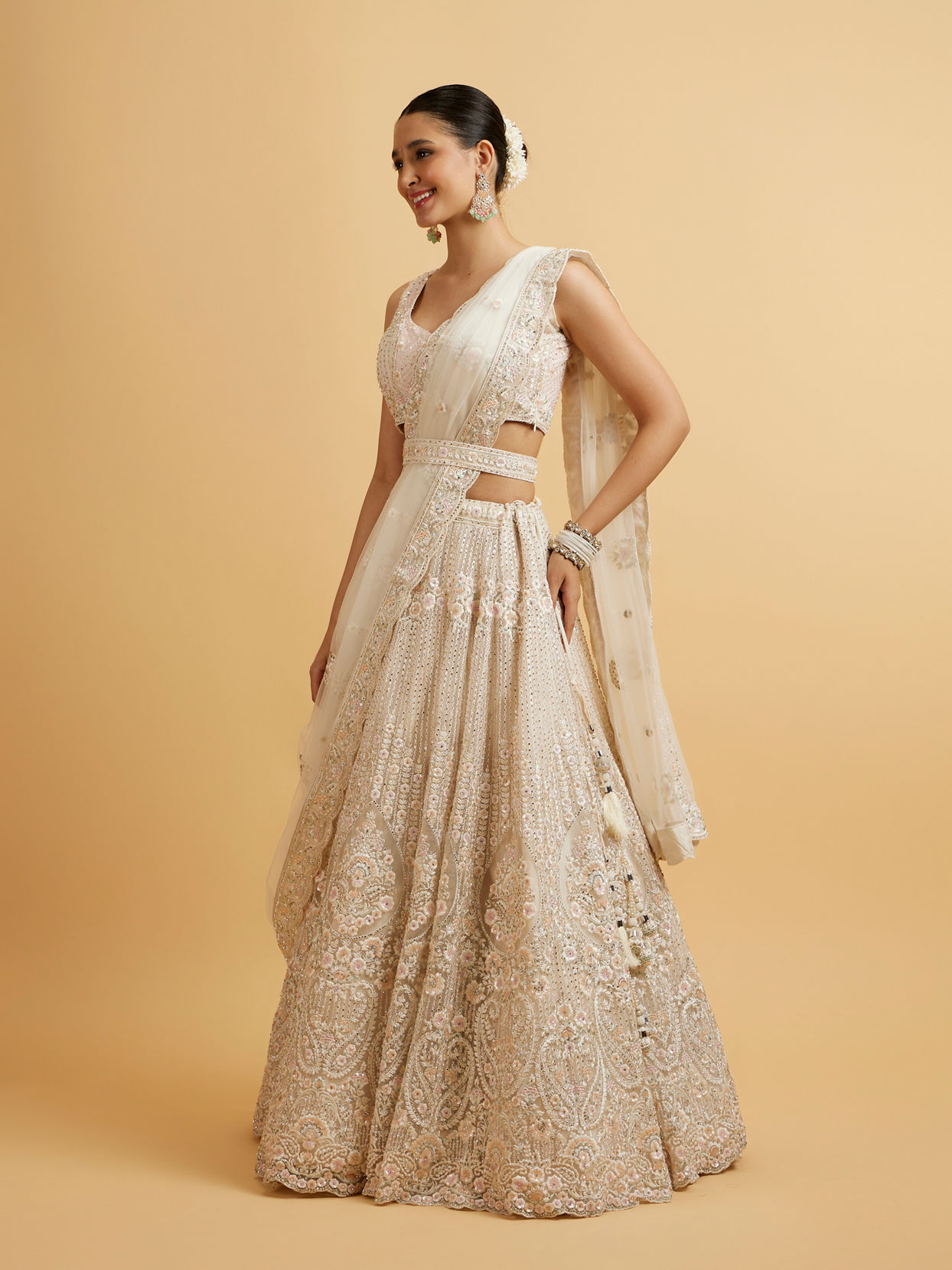 alt message - Mohey Women Dark Cream Floral Paisley Embroidered Lehenga with Round Trimmed Latkans image number 2