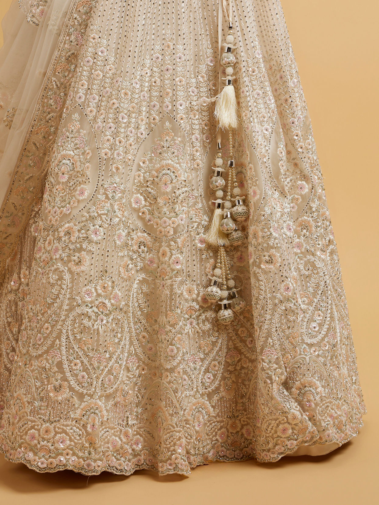 alt message - Mohey Women Dark Cream Floral Paisley Embroidered Lehenga with Round Trimmed Latkans image number 3