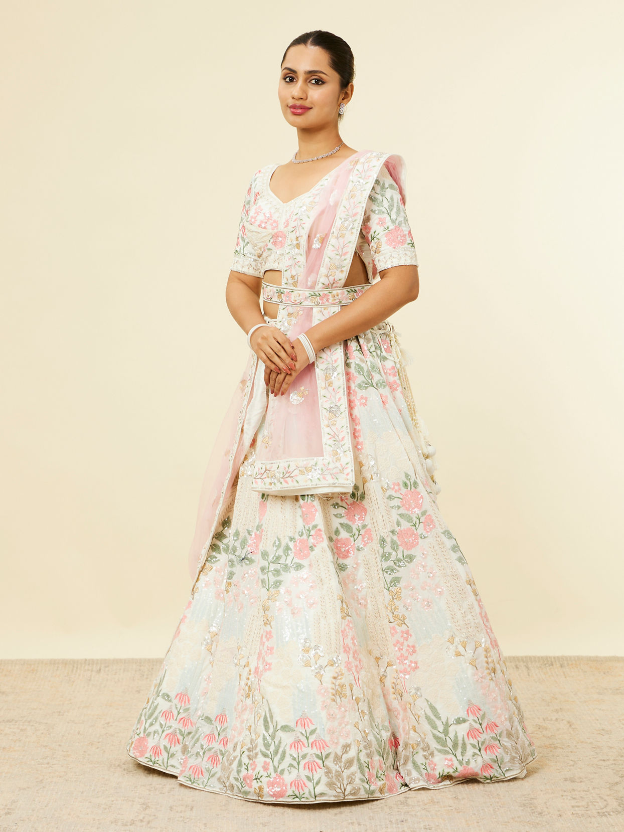 alt message - Mohey Women Cream Floral Sitara Embroidered Lehenga with Round Trimmed Latkans image number 2