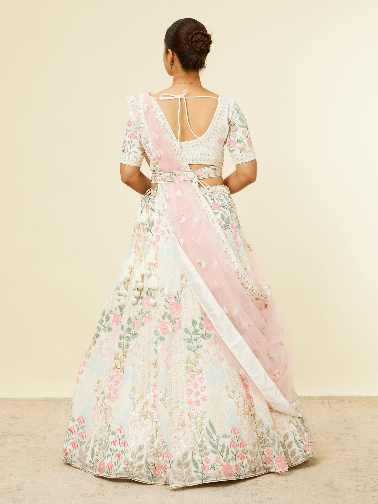 alt message - Mohey Women Cream Floral Sitara Embroidered Lehenga with Round Trimmed Latkans image number 4